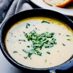 dark bowl with zuppa toscana soup and bread