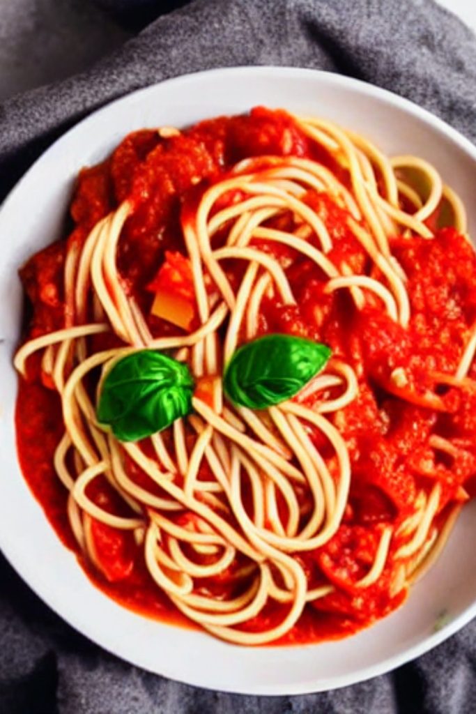 white bowl with spaghetti and marinara sauce