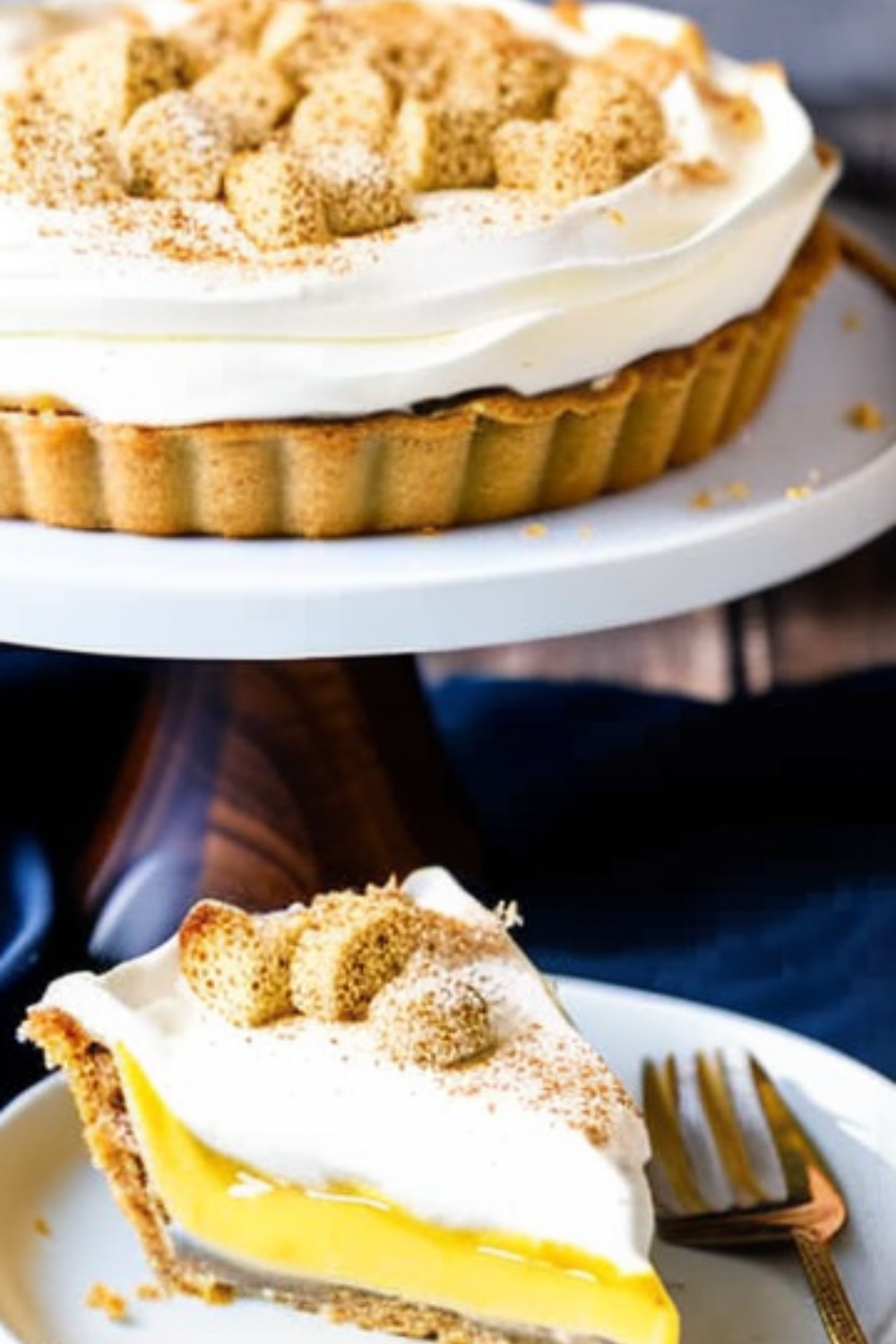 whole banana cream pie with a slice on a plate